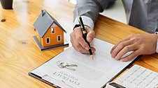 Businessmen Holding Pens, Signing Home Titles With Insurance, Care About Real Estate Services And The Idea Of Real Estate Agents O Stock Images