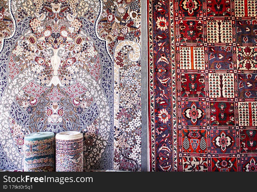 Persian rugs in various colors hanging on a wall