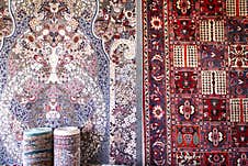 Persian Rugs In Various Colors Hanging On A Wall Royalty Free Stock Photography