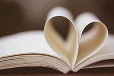 Close Up Heart Shape From Paper Book On Wooden Table Stock Photos