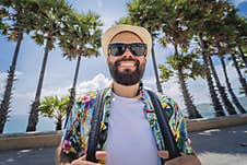 Young Traveler Man At Summer Holiday Vacation With Beautiful Palms And Seascapes At Background Stock Image