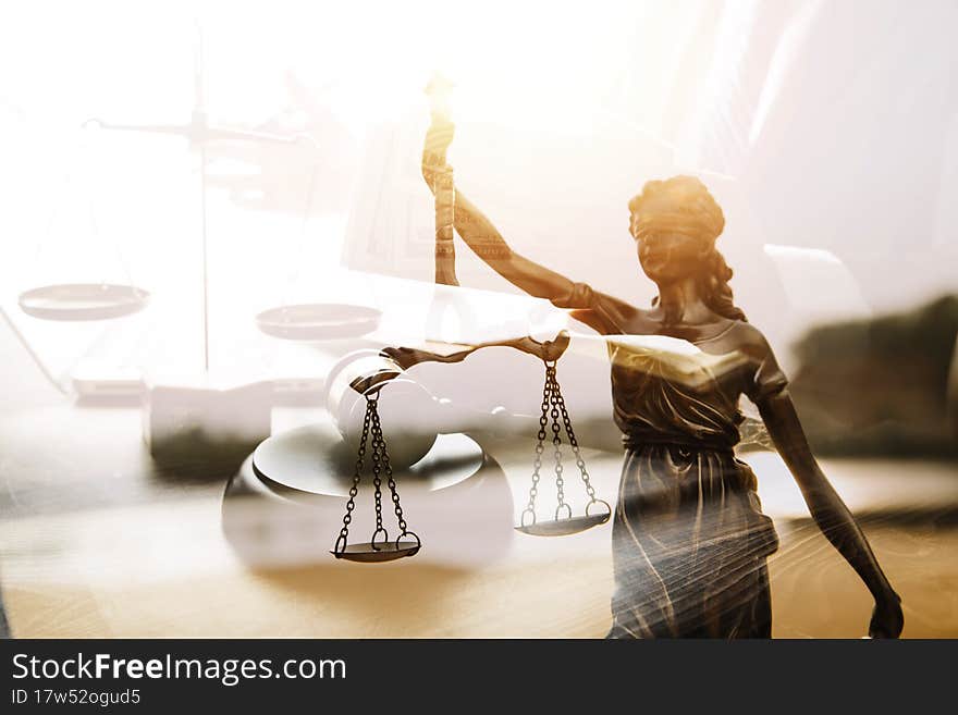 Justice and law concept.Male judge in a courtroom with the gavel, working with, computer and docking keyboard, eyeglasses, on table in morning light
