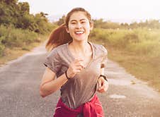 Young Fitness Woman Running On The Countryside Road In The Evening. Royalty Free Stock Photo