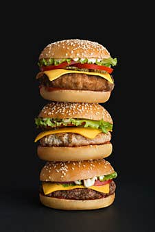 Stack Of Different Burgers On Black Background Stock Image