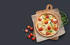 Margarita Pizza On A Board With Ingredients On A Black Background Royalty Free Stock Photo