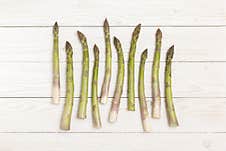 Asparagus Stems On White Wooden Table. Stock Photo