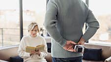Man Holding Gift Box Behind His Back Stock Photo