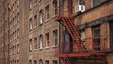 New York City Brick Building With Red Fire Escape Stock Image