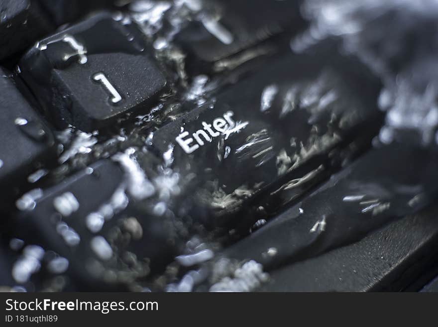 Black enter key under water, keyboard