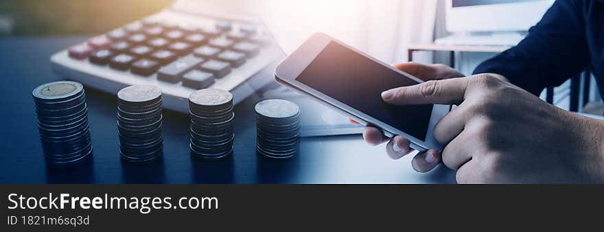 businessman working on desk office with using a calculator to calculate the numbers, finance accounting concept