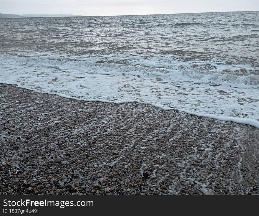 Evening seaside tour A distinctive beach with sand and cobblestones symmetrical