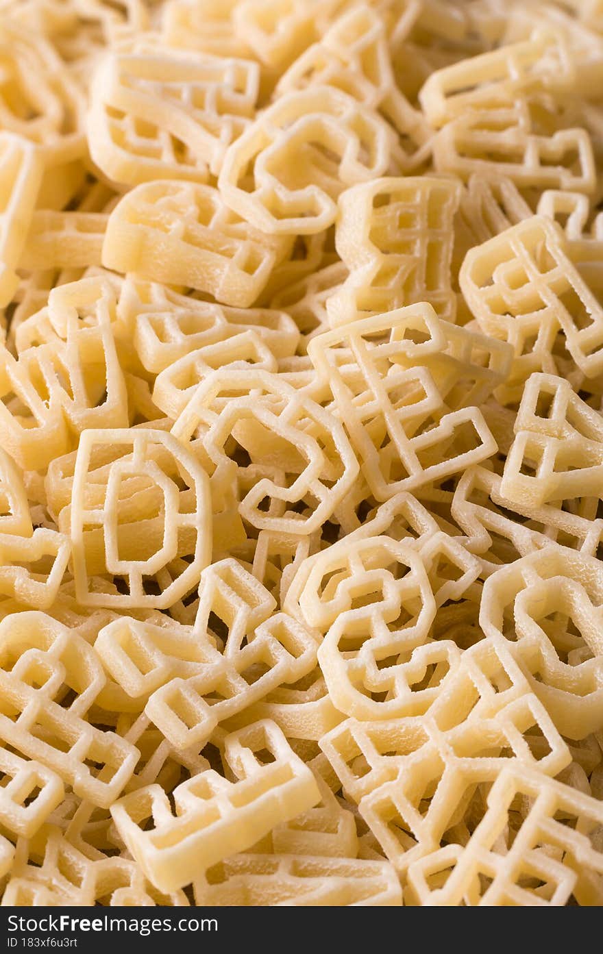 Closeup macro view of pasta letters or alphabet, full frame background, diet and food concept, taken in shallow depth of field. Closeup macro view of pasta letters or alphabet, full frame background, diet and food concept, taken in shallow depth of field