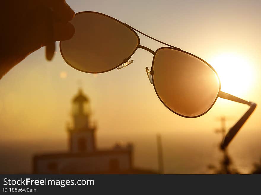 Aviator sunglasses in a hand during vacation.