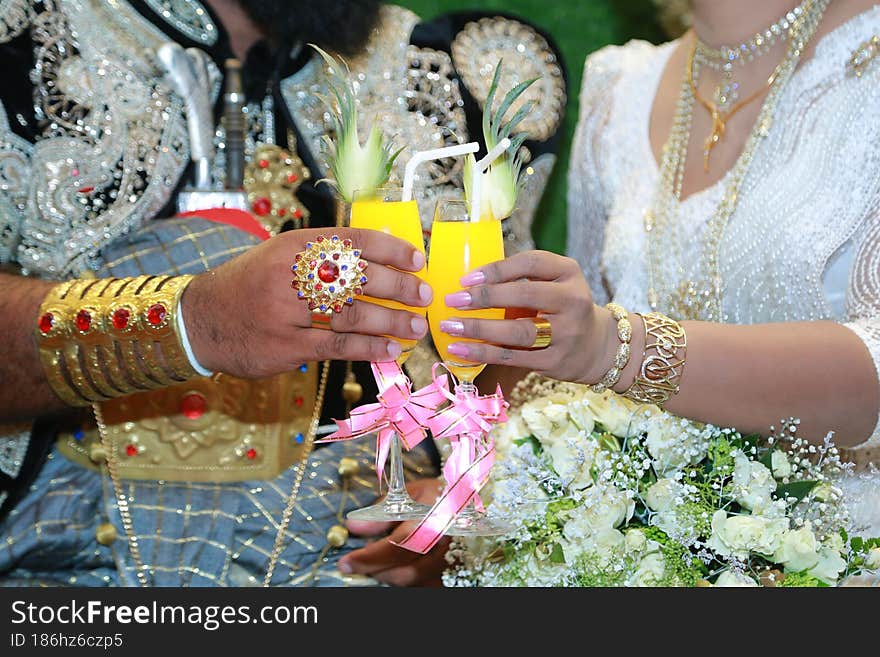 A married couple holding a drink in their hands