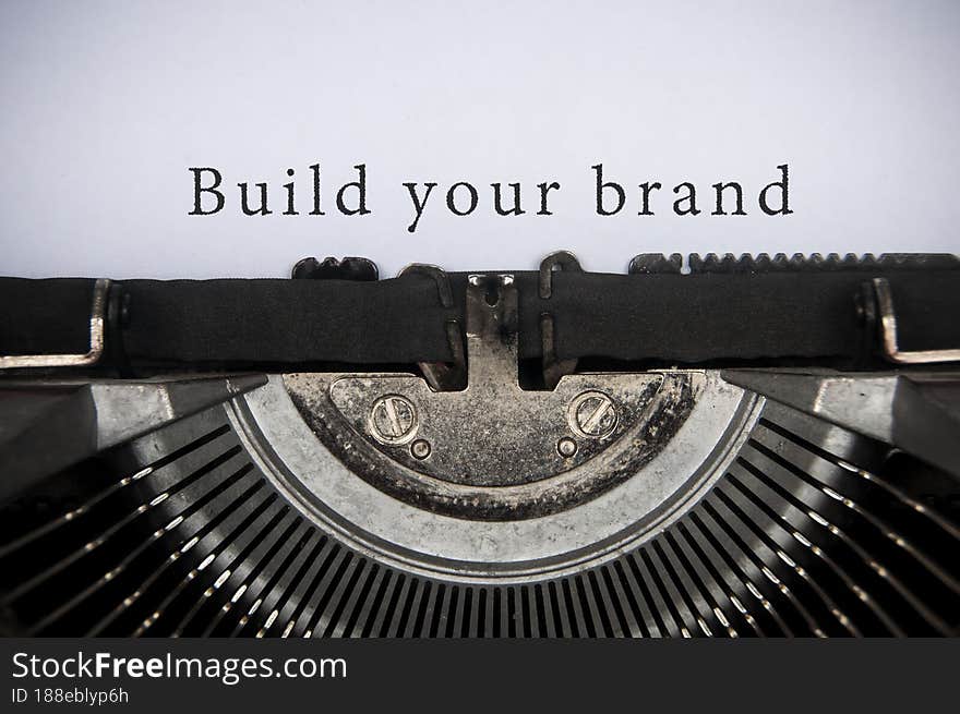 Build your brand text typed on an old vintage typewriter. Branding concept. Build your brand text typed on an old vintage typewriter. Branding concept