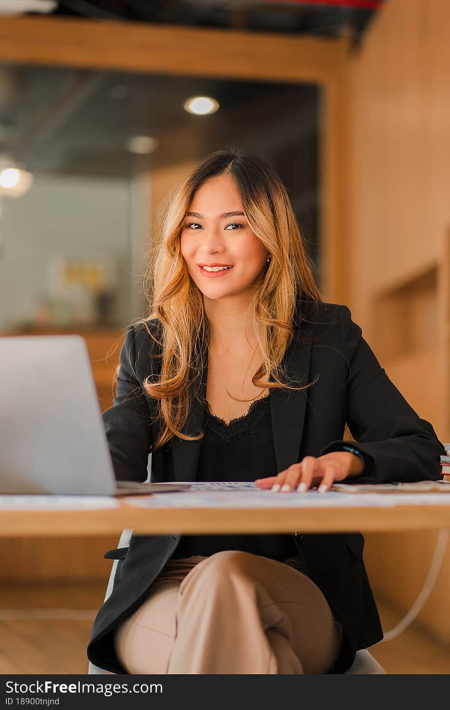 Businesswoman using laptop at desk of independent girl company reading financial graph chart Marketing analysis planning, Asian pe