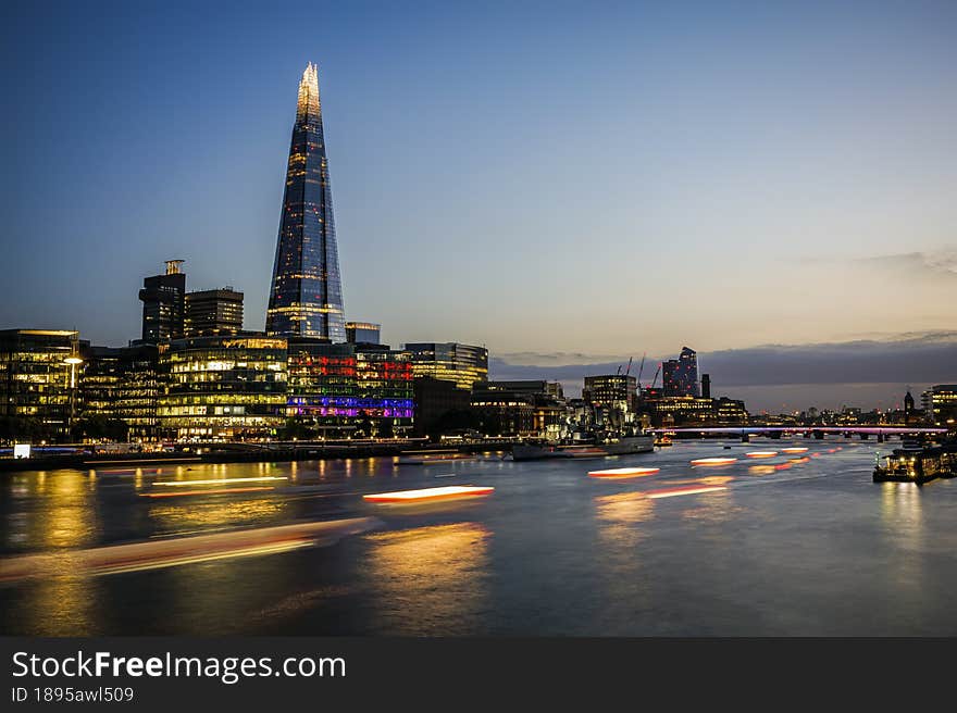 Dramatic sunset sky over the river Thames and the Shard of Glass rising over other modern steel and glass buildings. Photo taken on 10th of June 2022 in London, United Kingdom. Dramatic sunset sky over the river Thames and the Shard of Glass rising over other modern steel and glass buildings. Photo taken on 10th of June 2022 in London, United Kingdom