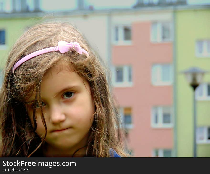 Polish little girl on the background of apartment blocks