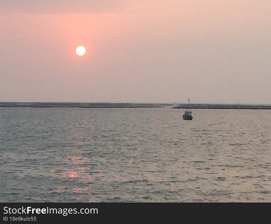 Sunset on the seashore of the Gulf of Thailand. Peaceful atmosphere.