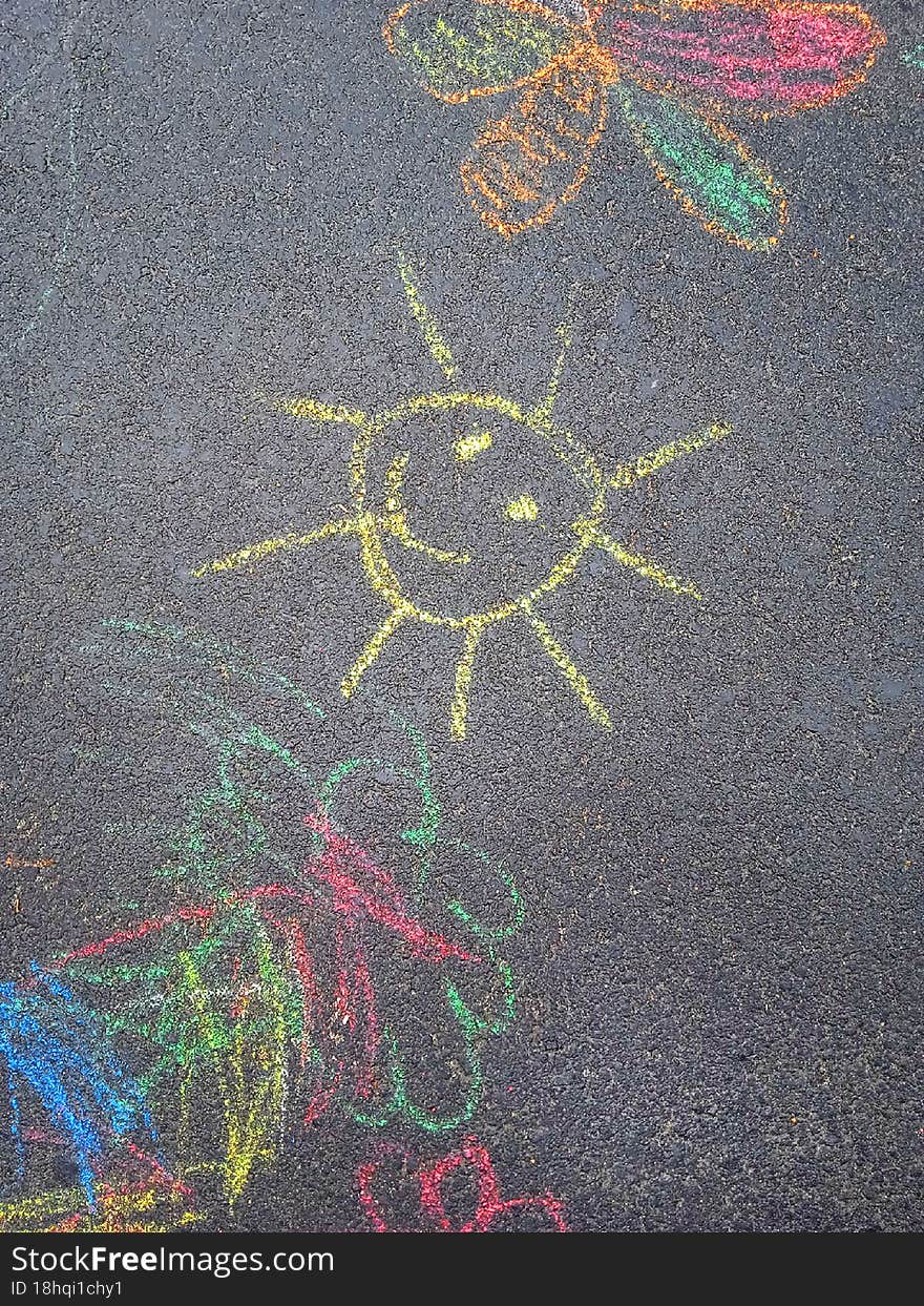 Children's drawings chalk are on asphalt. Children's drawings chalk are on asphalt