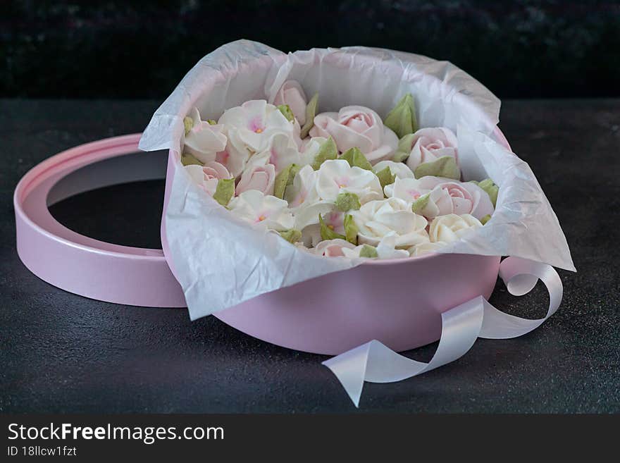 homemade marshmallows in a gift box on a dark background, a beautiful delicate bouquet of marshmallow flowers, holiday concept, gifts