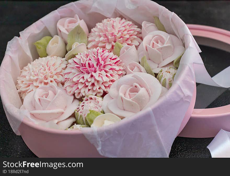 homemade marshmallows in a gift box on a dark background, a beautiful delicate bouquet of marshmallow flowers, holiday concept, gifts