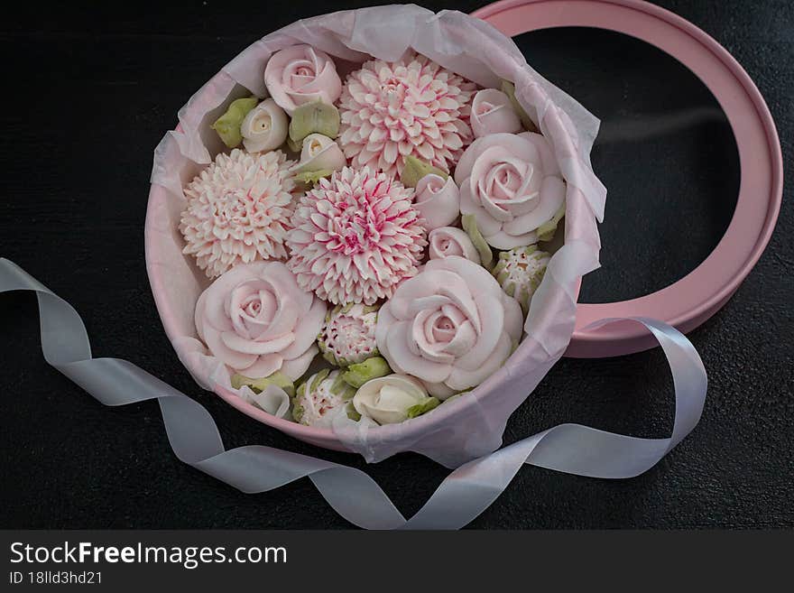 homemade marshmallows in a gift box on a dark background, a beautiful delicate bouquet of marshmallow flowers, holiday concept, gifts