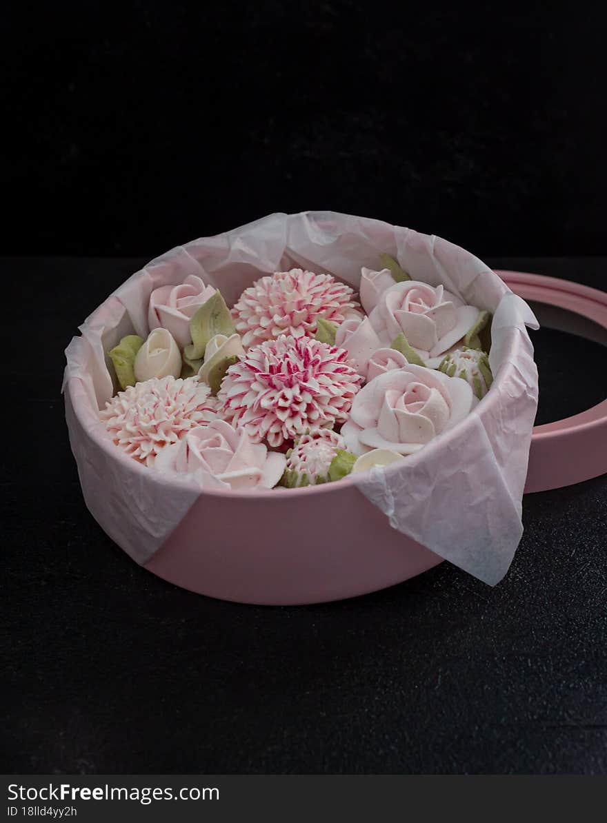 homemade marshmallows in a gift box on a dark background, a beautiful delicate bouquet of marshmallow flowers, holiday concept, gifts