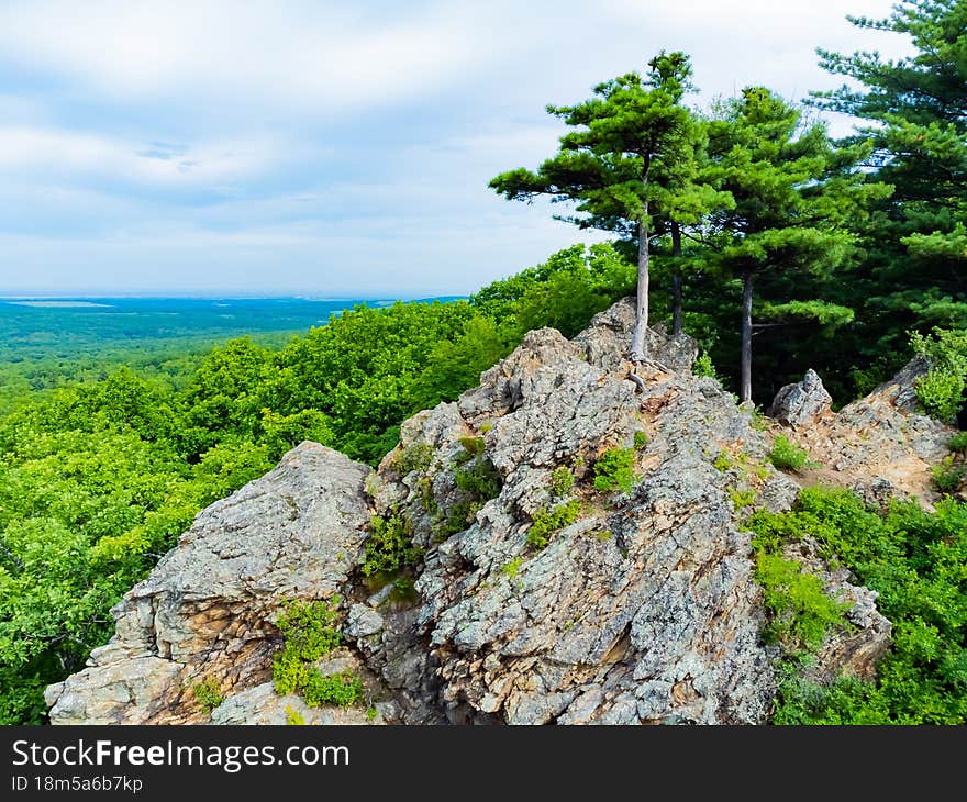 Rocky hill with abundant vegetation. Cedars grow right in the rocky rock. Nature protection zone near Khabarovsk in the Khekhtsir Nature Reserve. The Snake Hill is a favorite place for tourists to take pictures. The photo was taken from a drone.