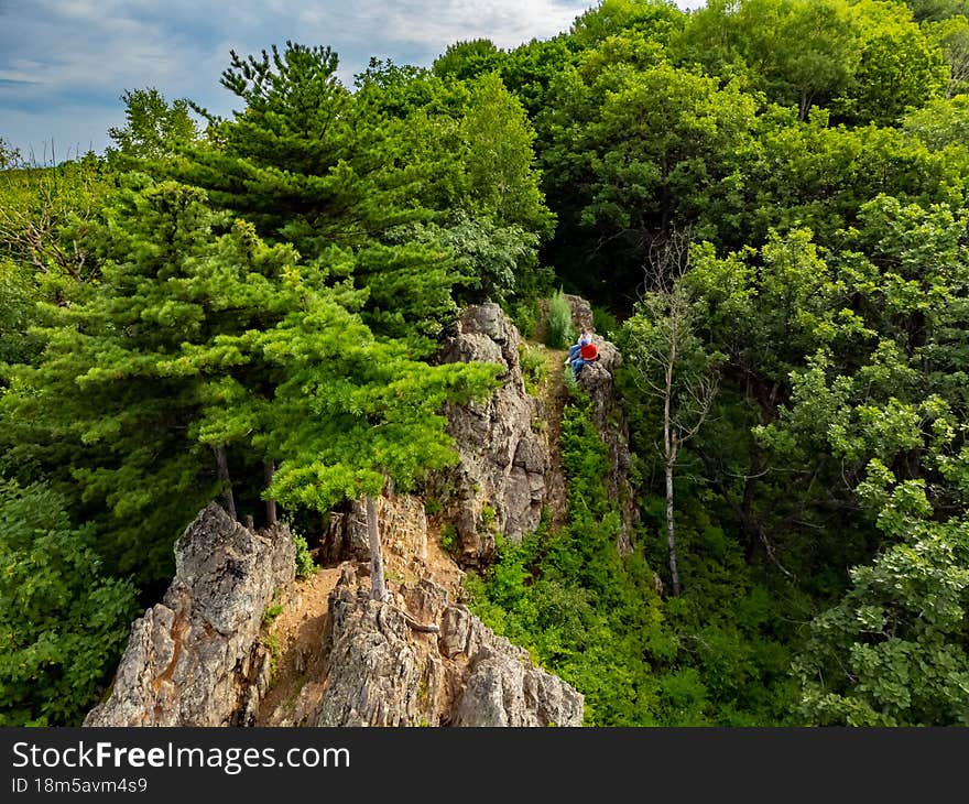 Rocky hill with abundant vegetation. Cedars grow right in the rocky rock. Nature protection zone near Khabarovsk in the Khekhtsir