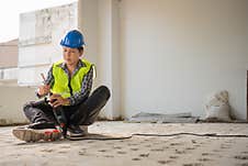 Construction Worker Using An Electric Jackhammer To Drill Perforator Equipment Making Holes Before Pouring The Floor To Be Strong Stock Photos