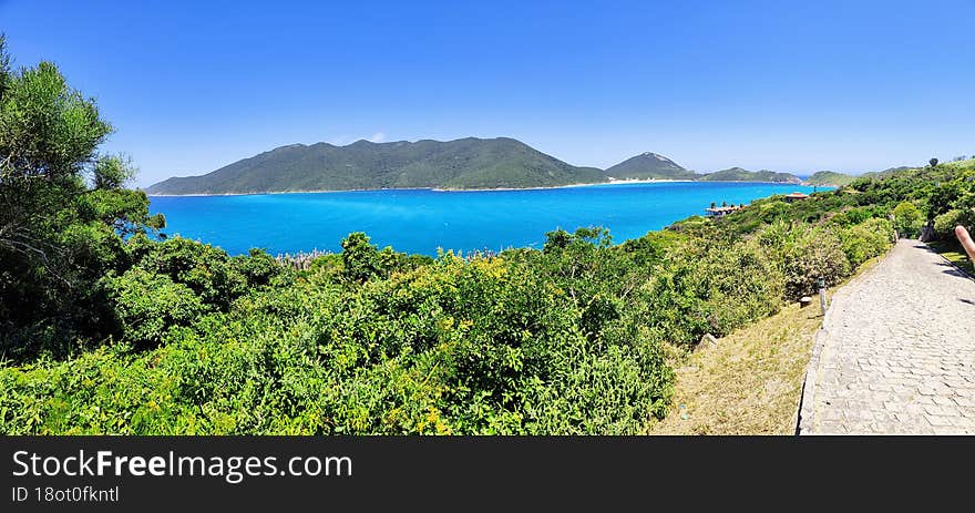 blooming blue sea in front of the lighthouse island in arraial do cabo