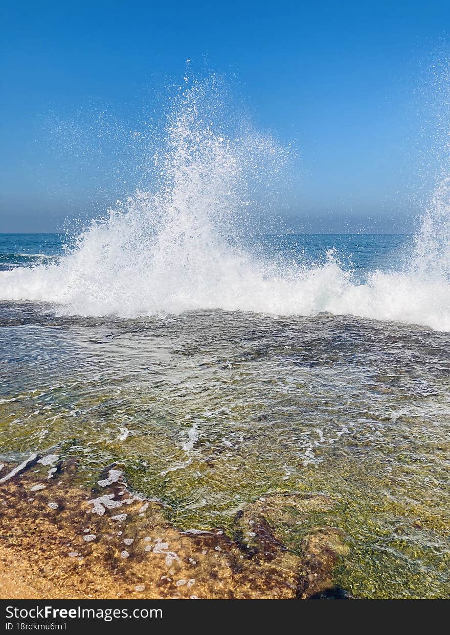 A beach is a narrow, gently sloping strip of land that lies along the edge of an ocean, lake, or river. Materials such as sand, pebbles, rocks, and seashell fragments cover beaches. Most beach materials are the products of weathering and erosion. Over many years, water and wind wear away at the land. A beach is a narrow, gently sloping strip of land that lies along the edge of an ocean, lake, or river. Materials such as sand, pebbles, rocks, and seashell fragments cover beaches. Most beach materials are the products of weathering and erosion. Over many years, water and wind wear away at the land.