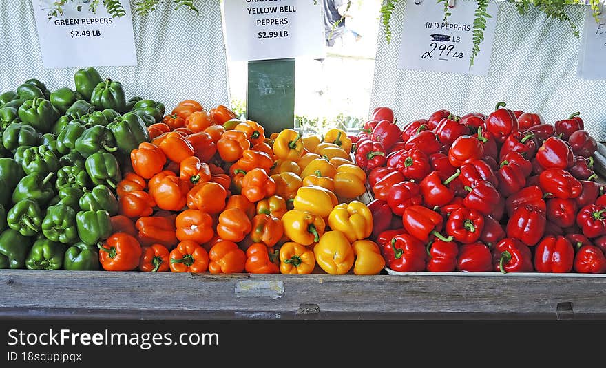 Green, orange, yellow and red organic peppers on the market for sale. Green, orange, yellow and red organic peppers on the market for sale