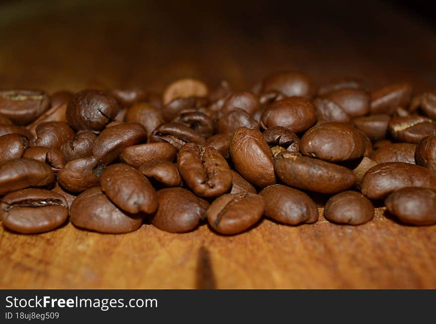 Coffee Beans On A Woody Background