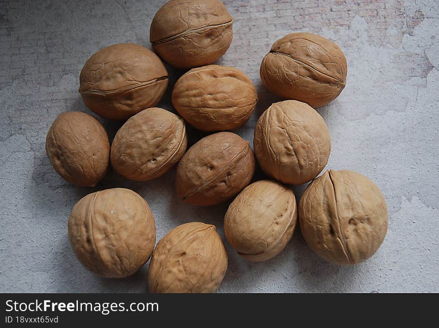 Walnuts with shells. Background of fresh walnuts.