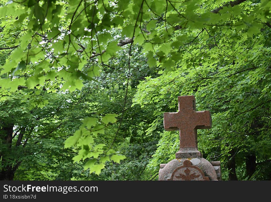 A tombstone in a cemetery in summer