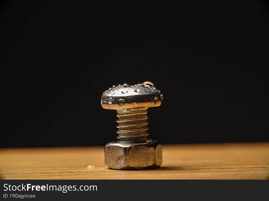 Macro view of a water drops on a screw