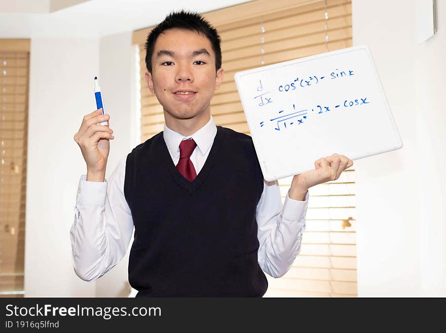 Student wearing uniform doing math with whiteboard