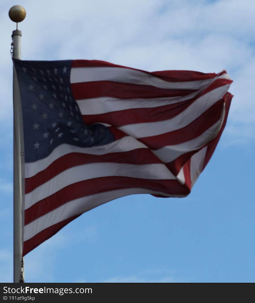 THe American flag, patriotism, hanging by a baseball field. Ready to play the national anthem, and PLAY BALL,  windy day, flag was blowing all about
13 red and white stripes and 50 stars on the blue. THe American flag, patriotism, hanging by a baseball field. Ready to play the national anthem, and PLAY BALL,  windy day, flag was blowing all about
13 red and white stripes and 50 stars on the blue