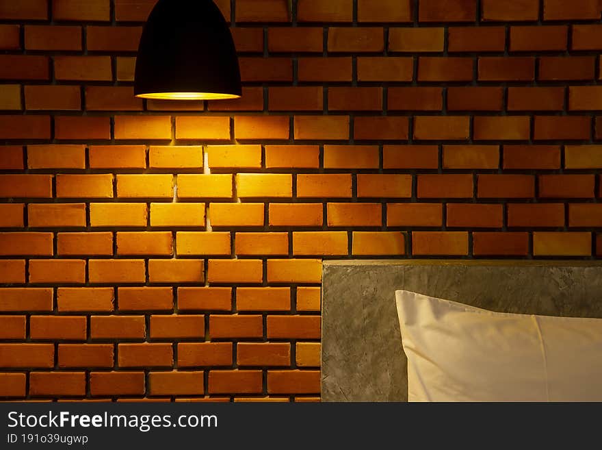 The ceiling lamp with the red brick wall background. The bedroom lighting setup concept