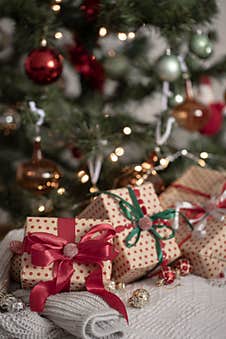 Festive Gift Boxes Under The Christmas Tree, Close-up. Royalty Free Stock Images