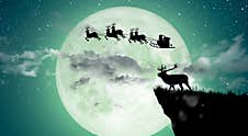 Silhouette Of Santa Claus Flying Over The Full Moon Royalty Free Stock Photography