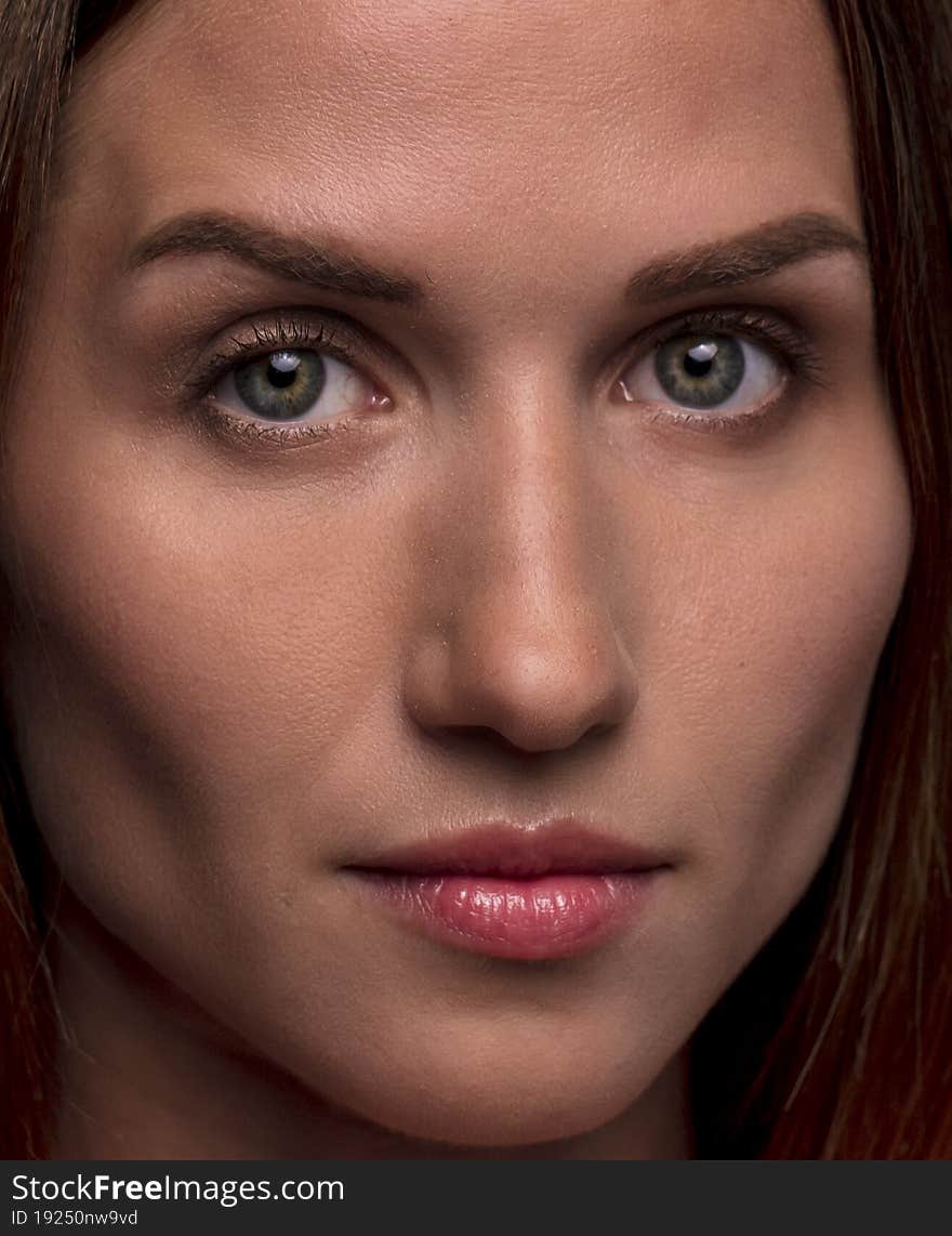 Studio portrait on a dark background of a beautiful young woman. Studio portrait on a dark background of a beautiful young woman