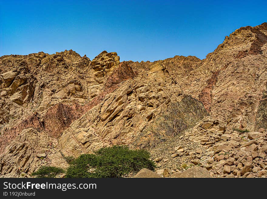 canyon of the yellow sandy mountains in the desert of Jordan near the city of Aqaba, on the shores of the Red Sea