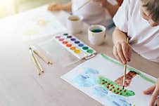 Children Paint Green Grass With A Tree And Blue Clouds Royalty Free Stock Images