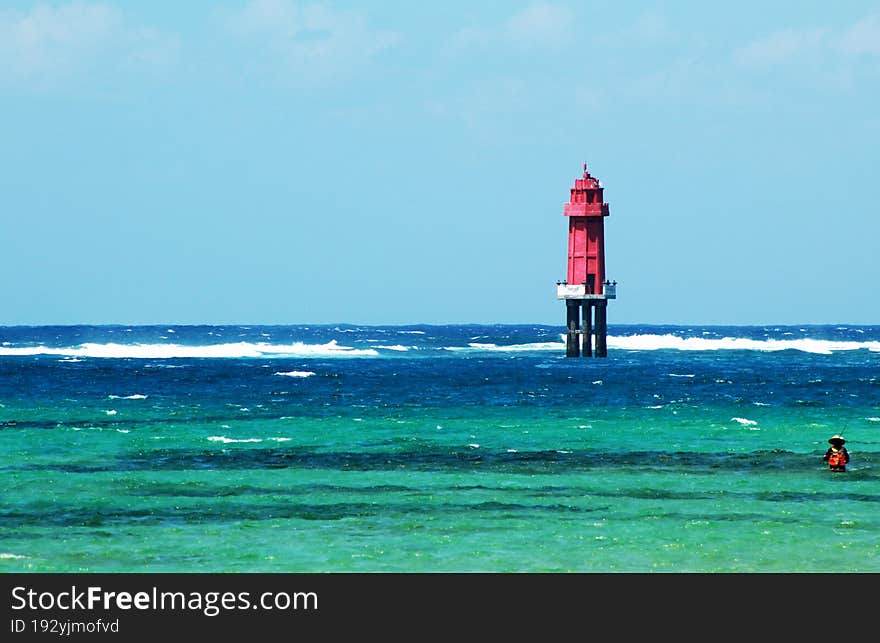the angler is on the beach of sanur close to the lighthouse. the angler is on the beach of sanur close to the lighthouse
