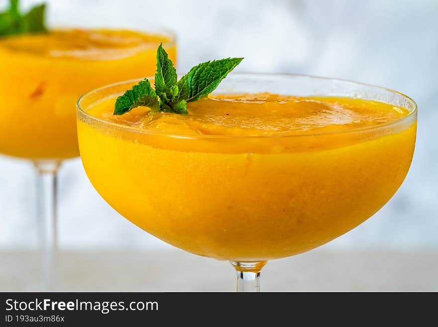 Frozen mango daiquiri with white rum garnished with fresh mint