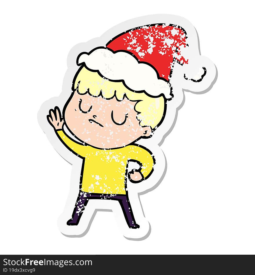 Distressed Sticker Cartoon Of A Grumpy Boy Wearing Santa Hat