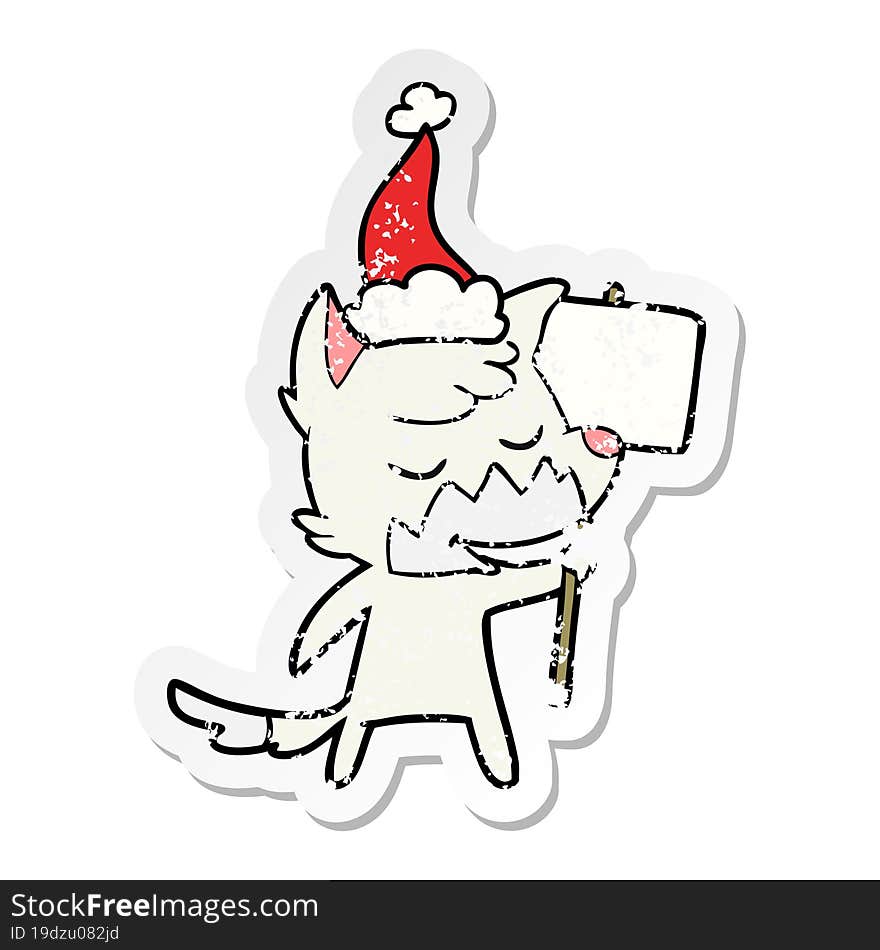 friendly distressed sticker cartoon of a fox wearing santa hat